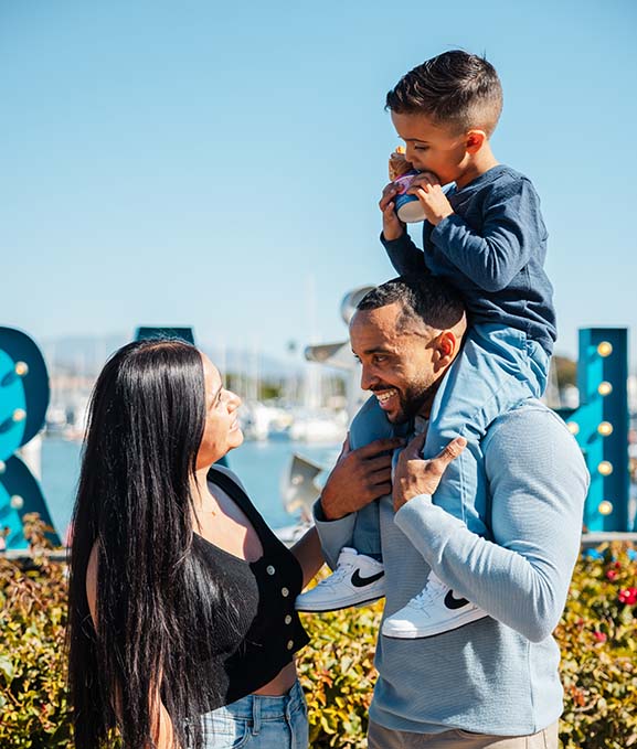 Family enjoying an ice cream cone at Ventura Harbor Village.